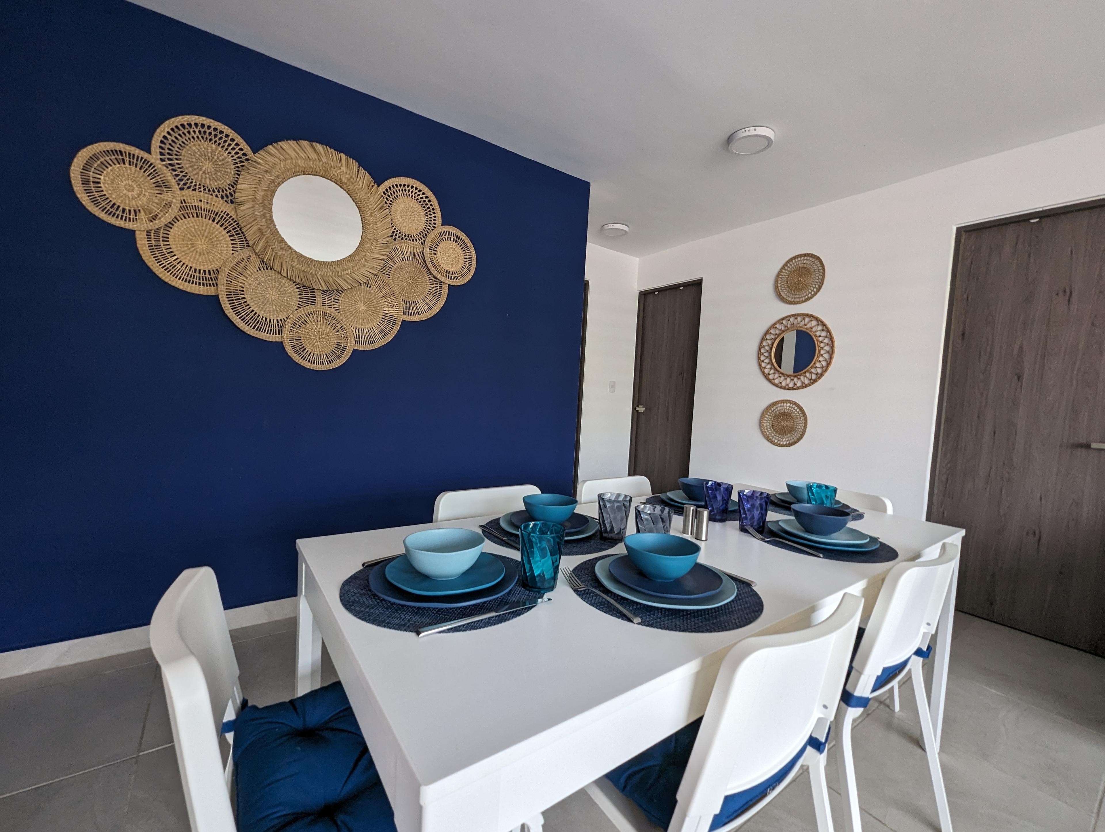 Comedor con pared azul marino y decoración de ratán — Azul 102